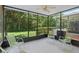 Screened patio with seating, ceiling fan, and scenic view of the backyard and landscaping at 934 Rock Harbor Ave, Orlando, FL 32828