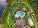 Overhead view of the resort-style amenities including a winding pool, putting green, and tennis court at 9844 Beach Port Dr, Winter Garden, FL 34787