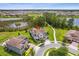 This aerial view highlights the home's location on a landscaped lot near walking path, water, and other residences at 9844 Beach Port Dr, Winter Garden, FL 34787