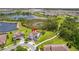 A beautiful lakefront property with lush landscaping and a charming blue exterior stands out in this aerial view at 9844 Beach Port Dr, Winter Garden, FL 34787