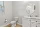 Bright bathroom featuring a vanity with white cabinets and an oval mirror at 9844 Beach Port Dr, Winter Garden, FL 34787