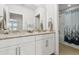 This bathroom features a double vanity with granite countertops, and a shower with themed curtain at 9844 Beach Port Dr, Winter Garden, FL 34787