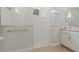 Walk-in shower with marble-look tile, rainfall showerhead and an adjacent vanity at 9844 Beach Port Dr, Winter Garden, FL 34787
