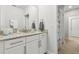 Bathroom with granite countertop, white cabinets, and decorative elements at 9844 Beach Port Dr, Winter Garden, FL 34787