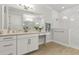 Bright bathroom with a white vanity, quartz countertop, large mirror and glass enclosed shower at 9844 Beach Port Dr, Winter Garden, FL 34787
