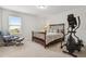 This spacious bedroom features a comfortable chair and exercise equipment at 9844 Beach Port Dr, Winter Garden, FL 34787