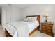 Comfortable bedroom with a wood frame bed, a nightstand with drawers, and soft carpet at 9844 Beach Port Dr, Winter Garden, FL 34787