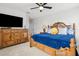 This bedroom has a cozy bed with matching wooden dresser and TV at 9844 Beach Port Dr, Winter Garden, FL 34787