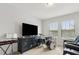 Entertainment space with a TV, drums, and comfortable seating area at 9844 Beach Port Dr, Winter Garden, FL 34787