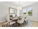 Bright dining room featuring a modern chandelier, elegant decor, and plenty of natural light at 9844 Beach Port Dr, Winter Garden, FL 34787