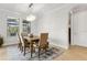 Well-lit dining room featuring a wooden table, seating for six, and a modern chandelier at 9844 Beach Port Dr, Winter Garden, FL 34787