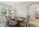 Charming dining room with modern chandelier, natural light, and view into other rooms at 9844 Beach Port Dr, Winter Garden, FL 34787
