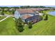 Aerial view of the home's backyard with screened-in patio and well-maintained lawn adjacent to a lake at 9844 Beach Port Dr, Winter Garden, FL 34787