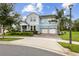 Charming two-story home features a well-manicured lawn, two-car garage, and inviting light blue color at 9844 Beach Port Dr, Winter Garden, FL 34787