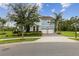 Charming two-story home features a well-manicured lawn, two-car garage, and inviting light blue color at 9844 Beach Port Dr, Winter Garden, FL 34787