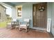 Inviting front porch with rocking chairs, brick pavers, and a charming welcome sign at 9844 Beach Port Dr, Winter Garden, FL 34787