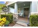Charming front porch with seating, a welcome sign, and a wreath on the door at 9844 Beach Port Dr, Winter Garden, FL 34787