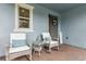 Charming front porch with seating and a small table at 9844 Beach Port Dr, Winter Garden, FL 34787