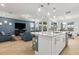 Open floor plan featuring a kitchen island with marble countertops, stainless steel appliances, and a view to the living room at 9844 Beach Port Dr, Winter Garden, FL 34787