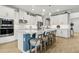 Kitchen island featuring marble countertops, modern appliances, barstool seating, pendant lighting, and contemporary style cabinets at 9844 Beach Port Dr, Winter Garden, FL 34787