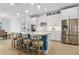Kitchen island featuring marble countertops, modern appliances, barstool seating, pendant lighting, and contemporary style cabinets at 9844 Beach Port Dr, Winter Garden, FL 34787