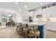 Kitchen island featuring marble countertops, modern appliances, barstool seating, pendant lighting, and contemporary style cabinets at 9844 Beach Port Dr, Winter Garden, FL 34787