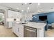 Open floor plan featuring a kitchen island with marble countertops, stainless steel appliances, and view to the living and dining rooms at 9844 Beach Port Dr, Winter Garden, FL 34787