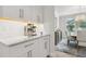 Kitchenette with white subway tile and light wood floors, with view into dining room at 9844 Beach Port Dr, Winter Garden, FL 34787