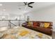Upstairs living room featuring a large leather sofa and stylish area rug at 9844 Beach Port Dr, Winter Garden, FL 34787