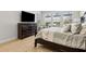 Comfortable main bedroom featuring a dresser with a television and comfortable seating beneath a window at 9844 Beach Port Dr, Winter Garden, FL 34787