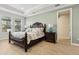 Serene bedroom features a dark wood bed frame, coordinated lamps, and an abundance of natural light at 9844 Beach Port Dr, Winter Garden, FL 34787