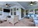 Covered patio featuring comfortable seating and ceiling fans at 9844 Beach Port Dr, Winter Garden, FL 34787