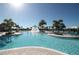 Beautiful outdoor pool featuring a central fountain and lush tropical landscaping for a resort-style experience at 9844 Beach Port Dr, Winter Garden, FL 34787
