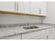Sink with granite countertop and white cabinets provides ample space and style at 9844 Beach Port Dr, Winter Garden, FL 34787