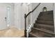 Stylish staircase with dark wood treads, an ornate railing, and natural light from the entry at 9844 Beach Port Dr, Winter Garden, FL 34787