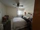Cozy bedroom with ceiling fan, window, and striped bedding at 101 Grand Plaza Dr # P40, Orange City, FL 32763