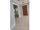Hallway features tile flooring, a mirrored wall, and an adjacent doorway at 101 Grand Plaza Dr # P40, Orange City, FL 32763