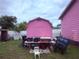 Backyard shed with a utility table next to the pink home at 1038 26Th St, Orlando, FL 32805