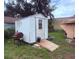 White storage shed in the backyard with backyard tools at 1038 26Th St, Orlando, FL 32805