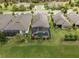 Aerial view of a single-Gathering home featuring a screened-in pool and well-manicured lawn at 1212 Zeek Ridge St, Clermont, FL 34715