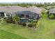 Aerial view of a home showcasing a screened-in pool, beautiful landscaping and ample lawn space at 1212 Zeek Ridge St, Clermont, FL 34715