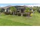 Backyard featuring a screened-in pool, a patio with seating, and lush tropical landscaping at 1212 Zeek Ridge St, Clermont, FL 34715