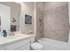 Cozy bathroom with a tiled shower/tub and white vanity with stone countertop at 1212 Zeek Ridge St, Clermont, FL 34715