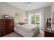 Comfortable bedroom with neutral tones, large window, and stylish furnishings and window at 1212 Zeek Ridge St, Clermont, FL 34715