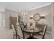 Spacious dining room with modern chandelier, neutral tones, and seamless flow to adjacent living spaces at 1212 Zeek Ridge St, Clermont, FL 34715