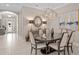 Open-concept dining room featuring modern decor, stylish lighting, and tile flooring throughout at 1212 Zeek Ridge St, Clermont, FL 34715