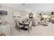 Elegant dining room with modern lighting fixture and an open layout connecting to the living area at 1212 Zeek Ridge St, Clermont, FL 34715