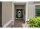 Inviting front entryway with tiled floor and decorative details on the front door and sidelights at 1212 Zeek Ridge St, Clermont, FL 34715