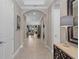 Spacious hallway with tile flooring and elegant archways leading to the living areas at 1212 Zeek Ridge St, Clermont, FL 34715
