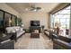 Relaxing outdoor living space featuring comfortable seating and a television for entertainment at 1212 Zeek Ridge St, Clermont, FL 34715